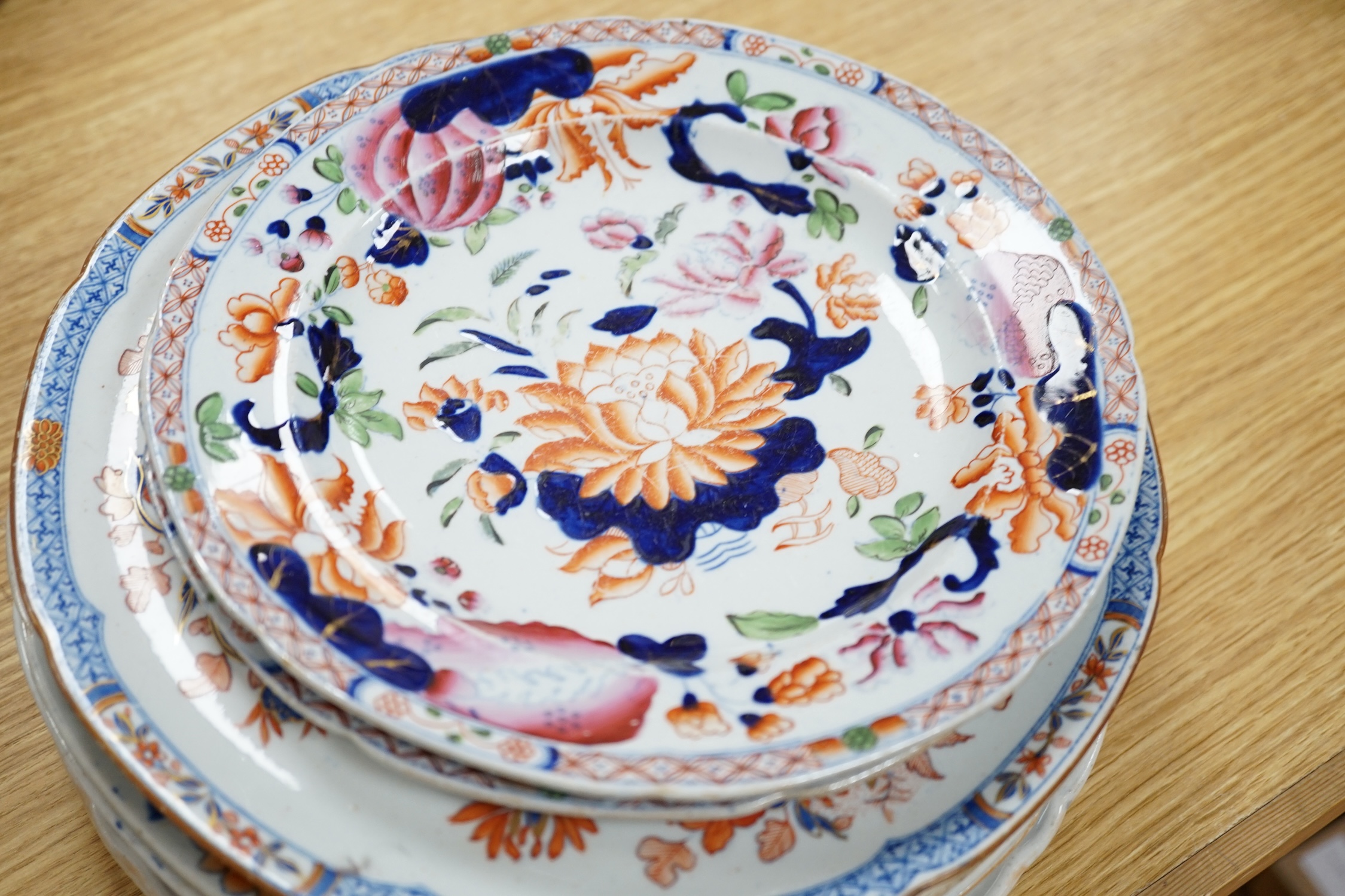 Seventeen ironstone items including two jardinières, a tureen and a quantity of plates, largest 28cm high. Condition - poor to fair